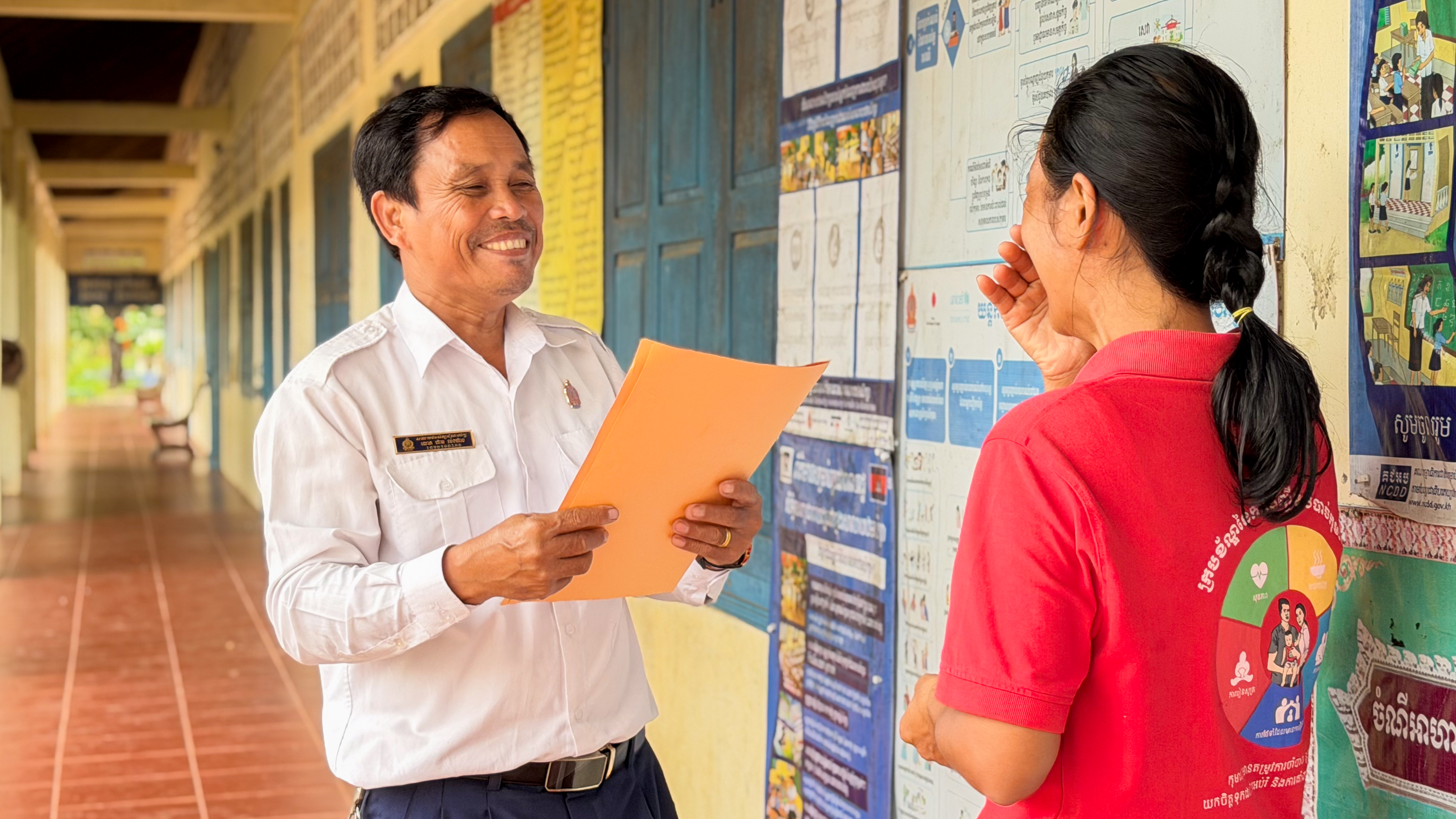 Meng Heang and the project officer feel happy after successfully solving the violence cases.  