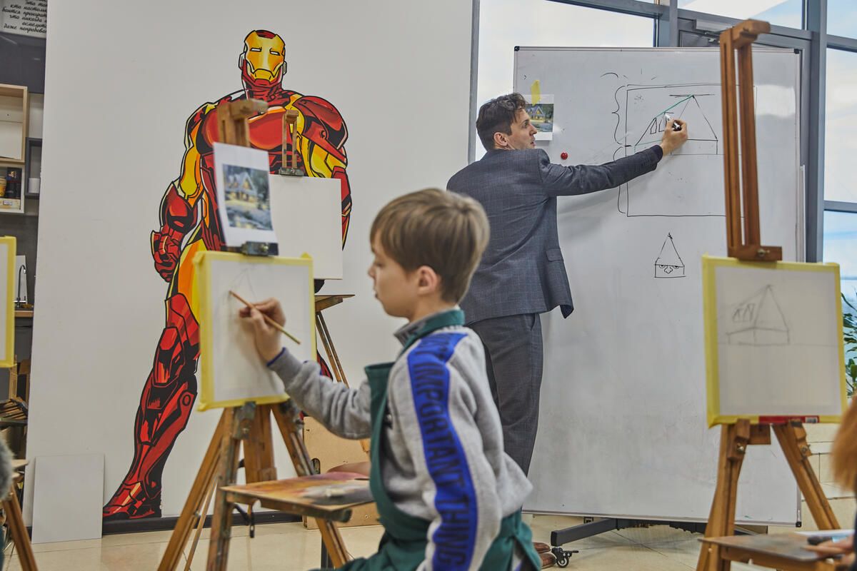 Anton*, 12, paints during an art therapy workshop in Poltava, Ukraine.
