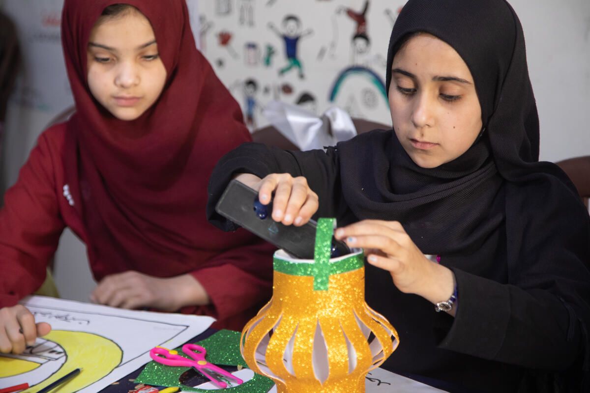 11-year-old Amal* (left) works on her craft project with her friends in the Child Friendly Space, Syria.
