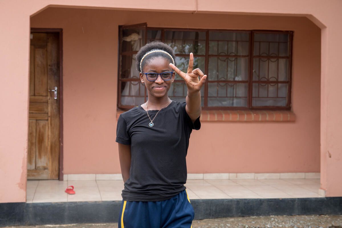 16-year-old Justina, a child climate activist, pictured in front of her house in Zambia.