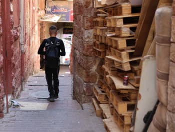 Yousef*, 14, walks to school in the West Bank with his school bag on his back.