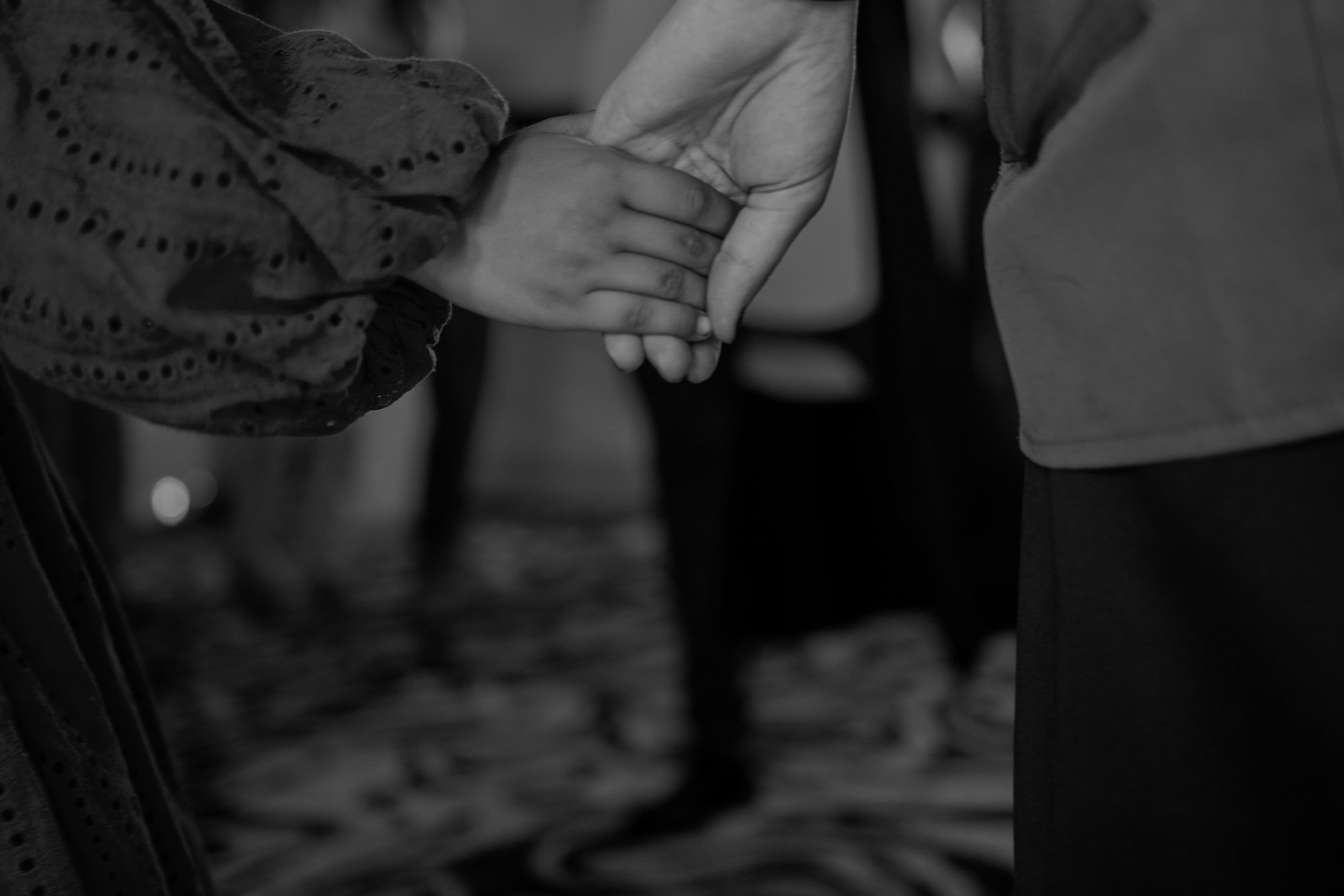 A girl gives her hand to a Save the Children worker in a children's learning space in Gaza.