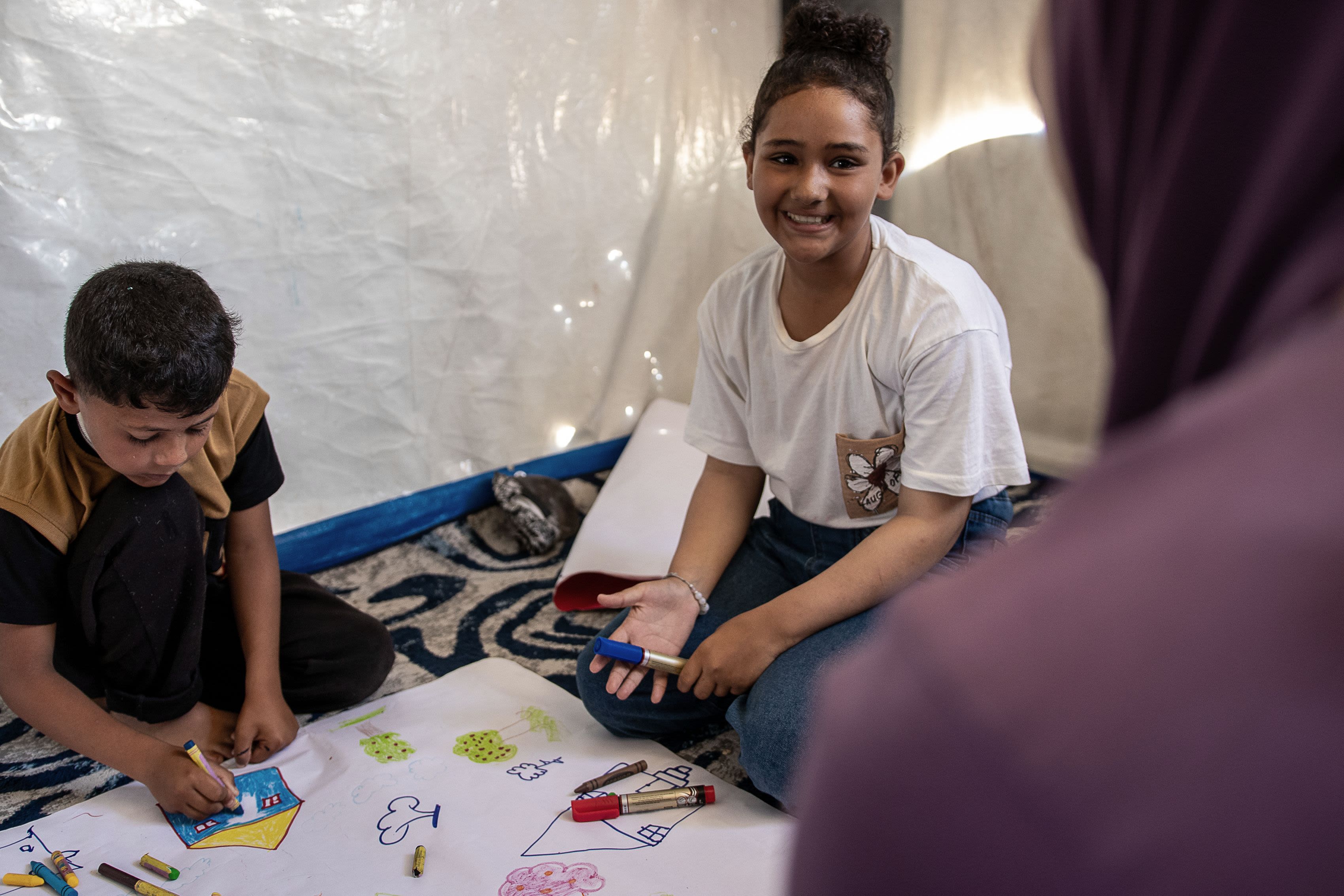 Shadi*, 8, and his cousin Aya*, 13, attend Save the Children's learning space in Gaza. Sacha Myers / Save the Children