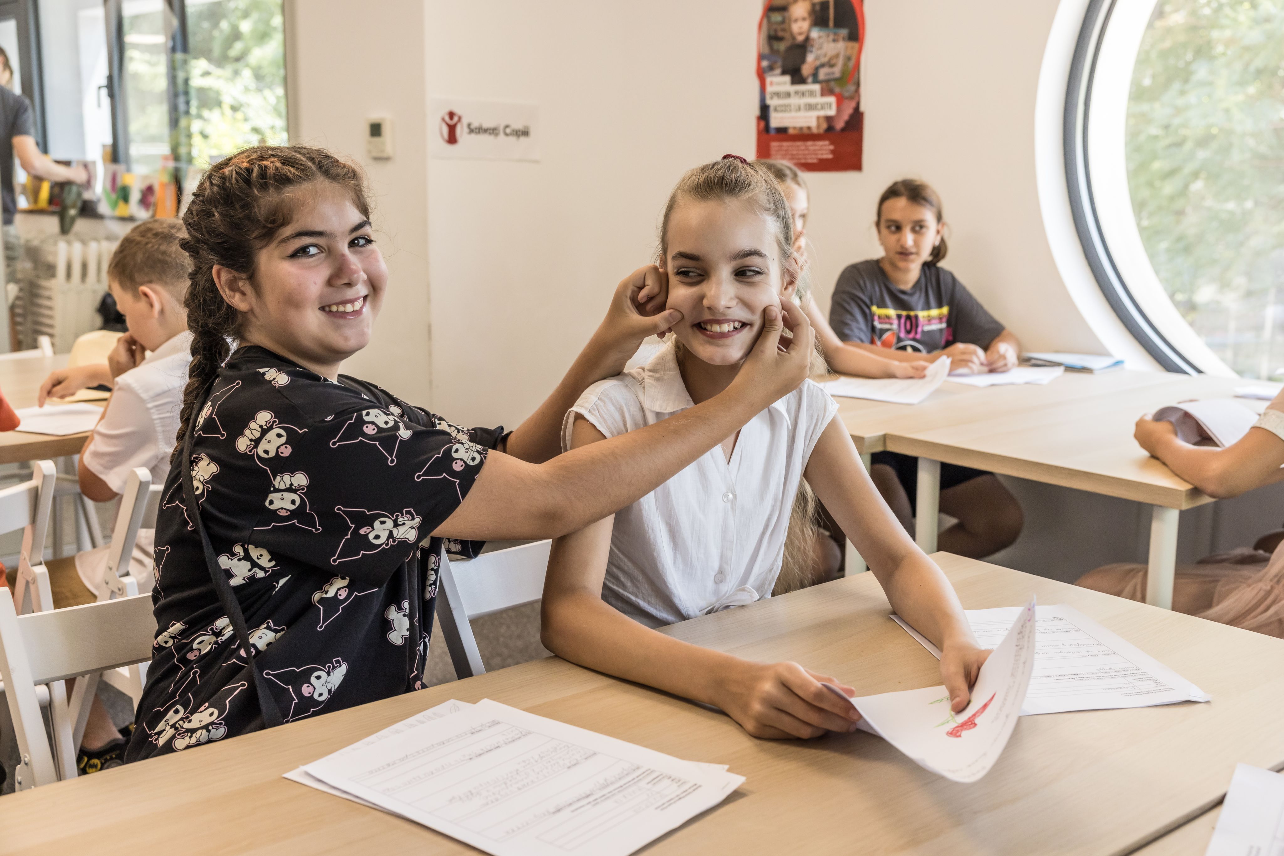 Milka*, 11, and Nastia*, 11, taking part in English lessons at Save the Children Romania's hub for children from Ukraine, Bucharest
