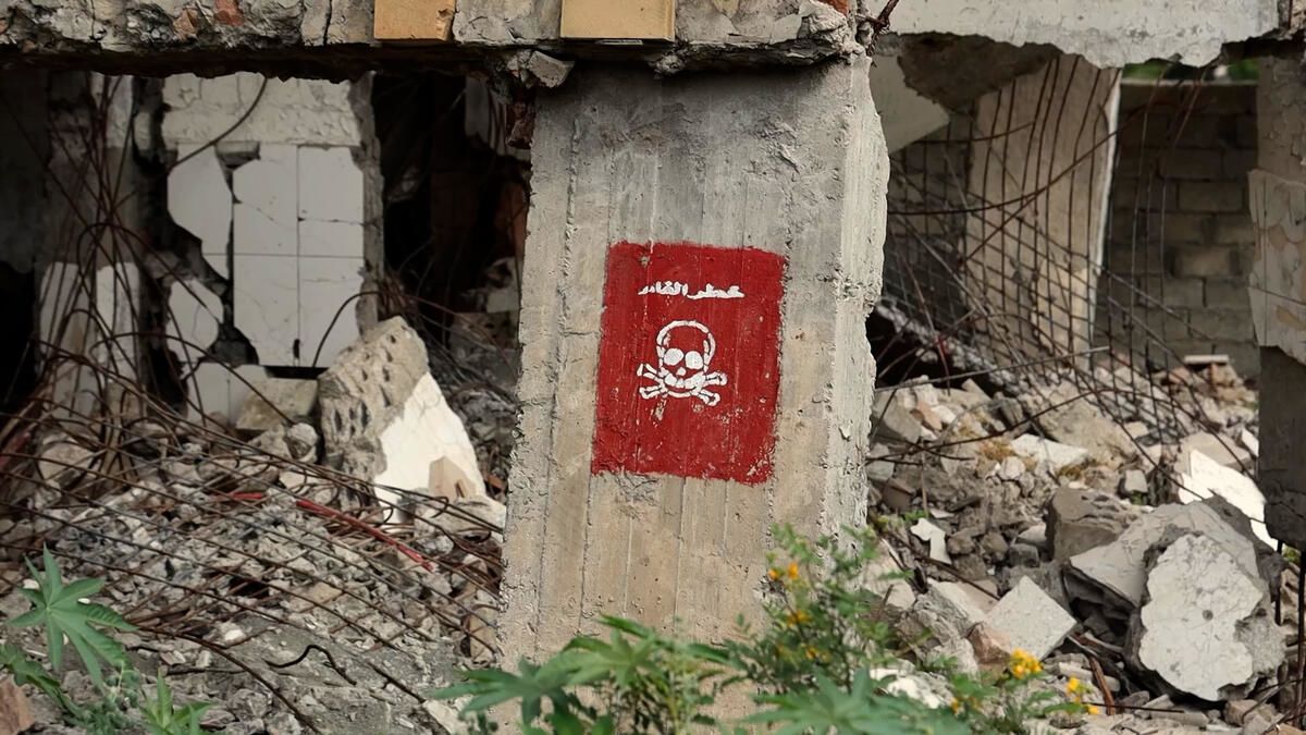 A sign reading 'Danger! Landmines" at a semi-destroyed school that's contaminated with landmines in Taiz, Yemen