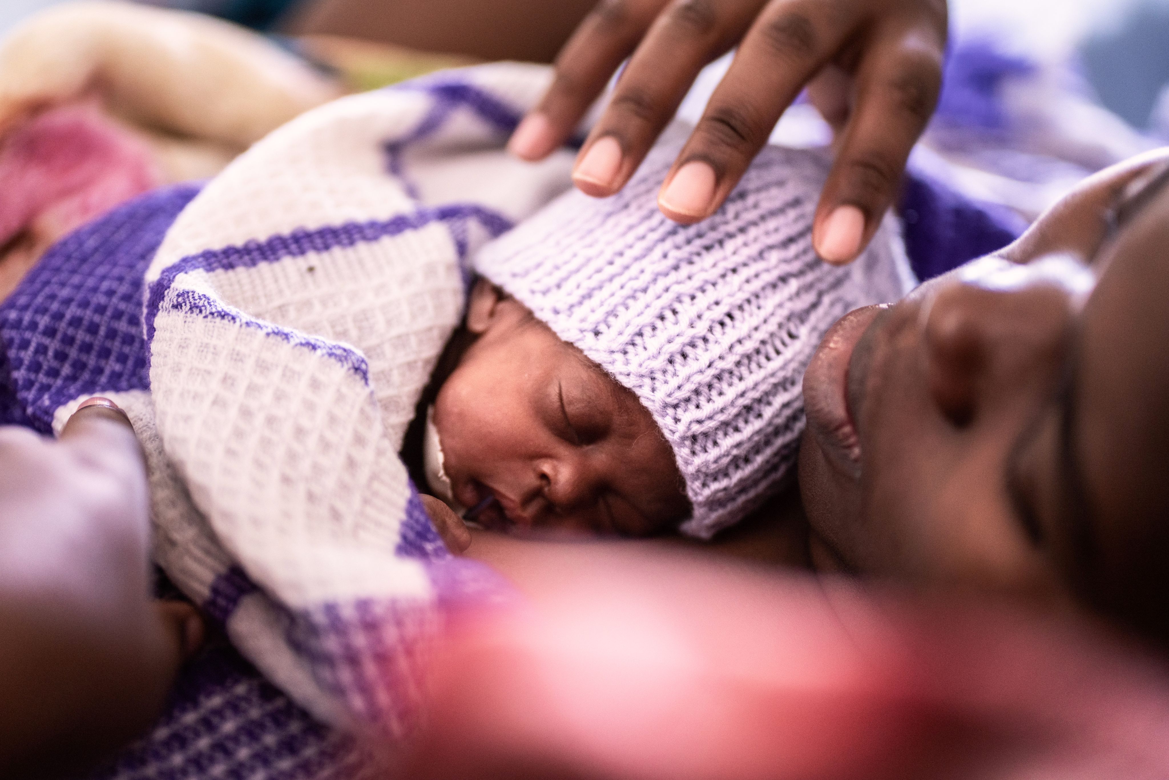 Diana, 21, practices Kangaroo Mother Care with her newborn baby, Blessings, in the maternity ward at a hospital in Bungoma, Kenya.