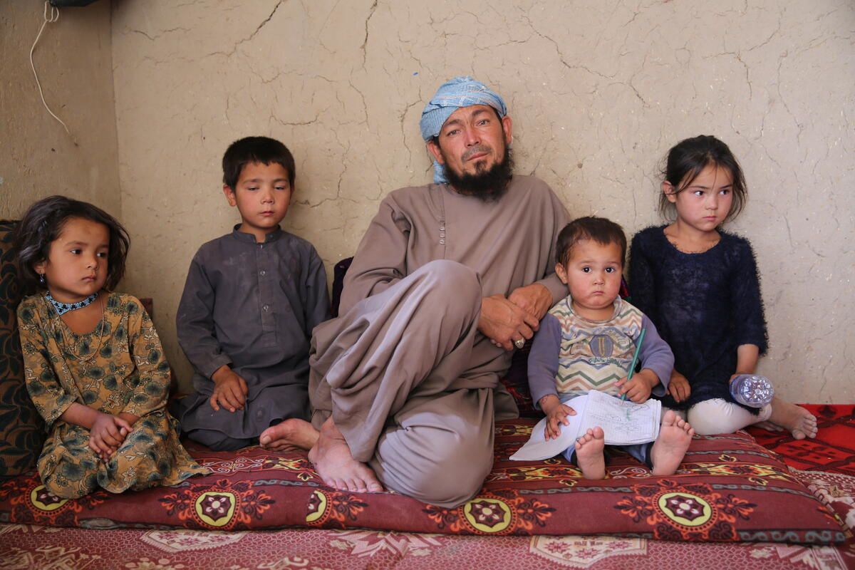 From left to right: Wazhma* (5), Mujib* (6), Khalid* (40), Amir* (2) and Mozhda (8) in their house