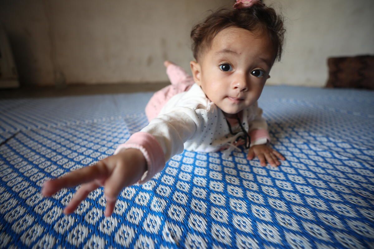 Nine-month-old Bara'a* on the mat at home in northeast Syria. Photo: Roni Ahmed / Save the Children