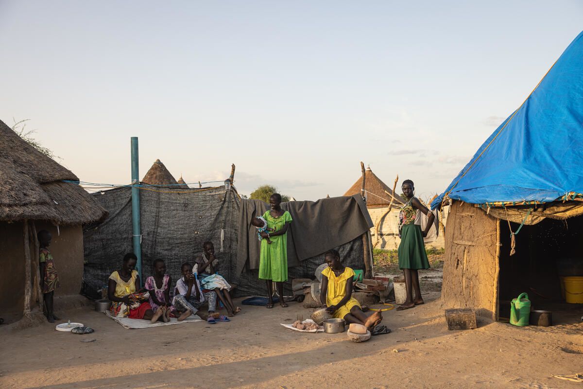 Jok* with his family outside their home in Akobo West, South Sudan. Photo: Esther Mbabazi / Save the Children