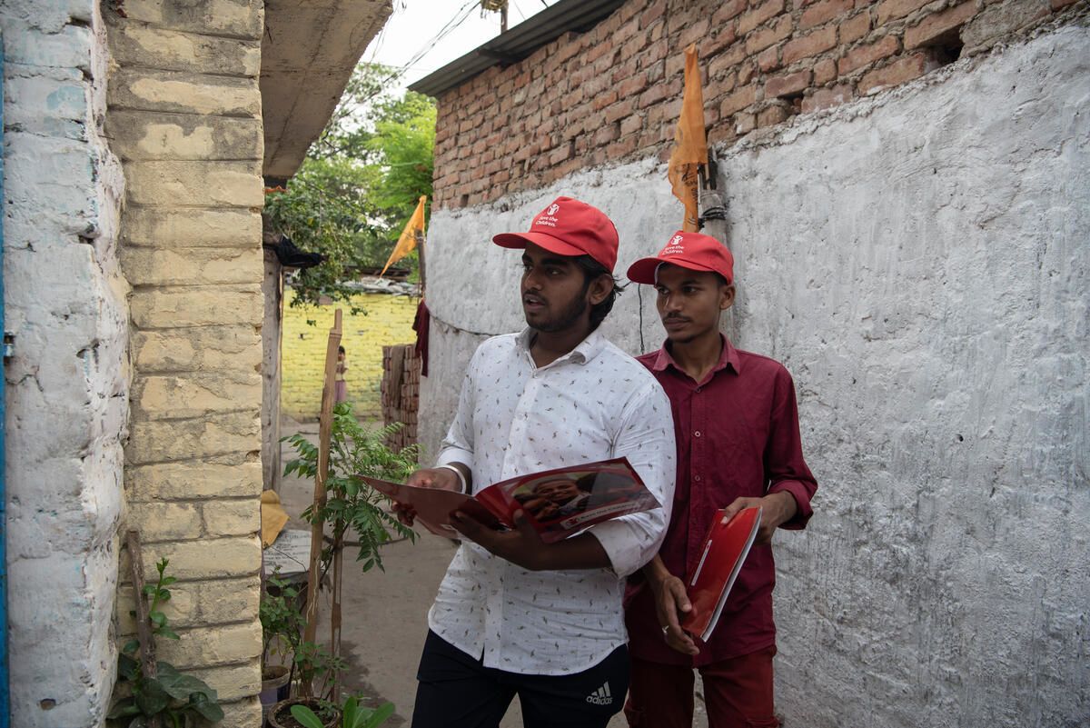 Krishna and his friend Vivek do door-to-door campaigning to teach people about climate change in their slum in Patna, India.