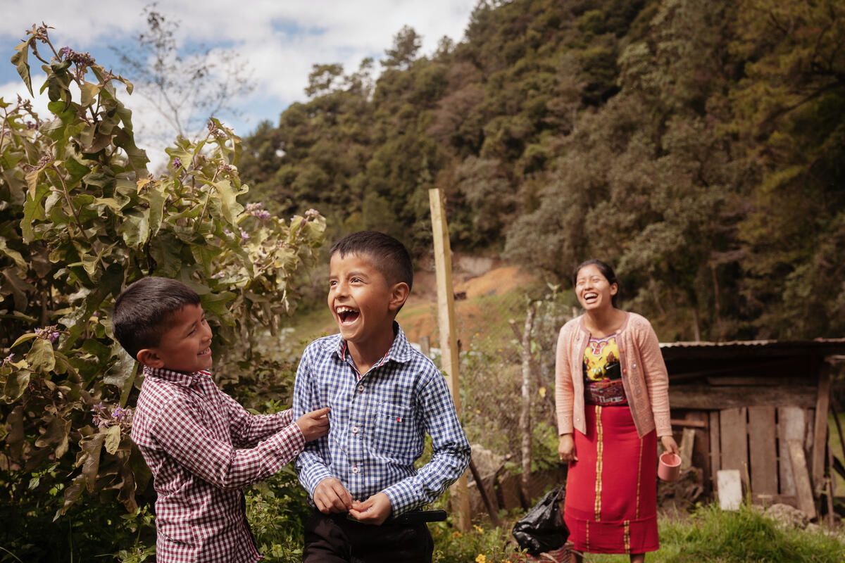 Brothers Edizon, 7, and Tomás, 9, with mum Rebeca, 27, at their farm in Quiche district, Guatemala