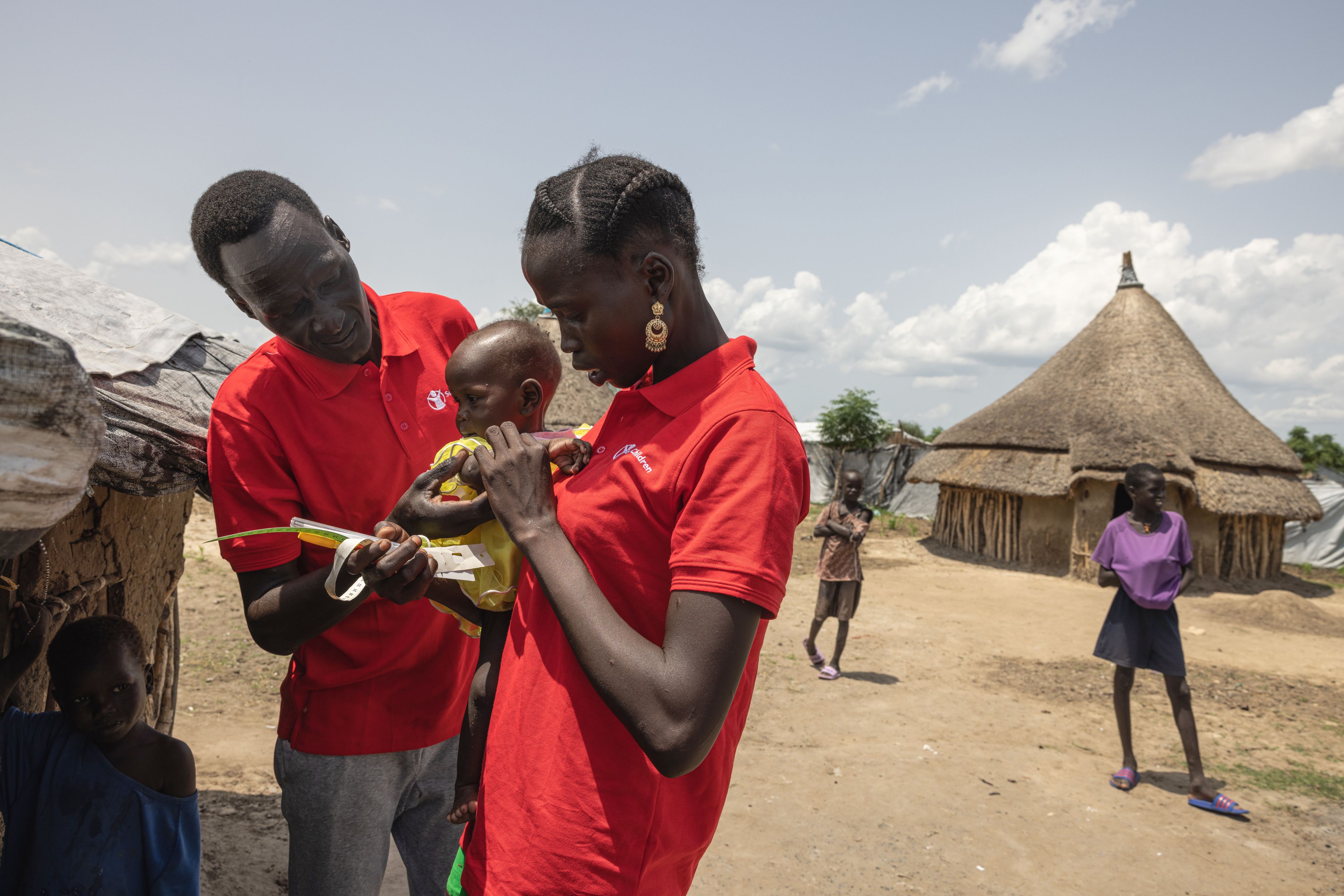 Community Nutrition Worker Nyawany, 27, visits one-year-old Machar*, who is receiving treatment for severe acute malnutrition in South Sudan. 