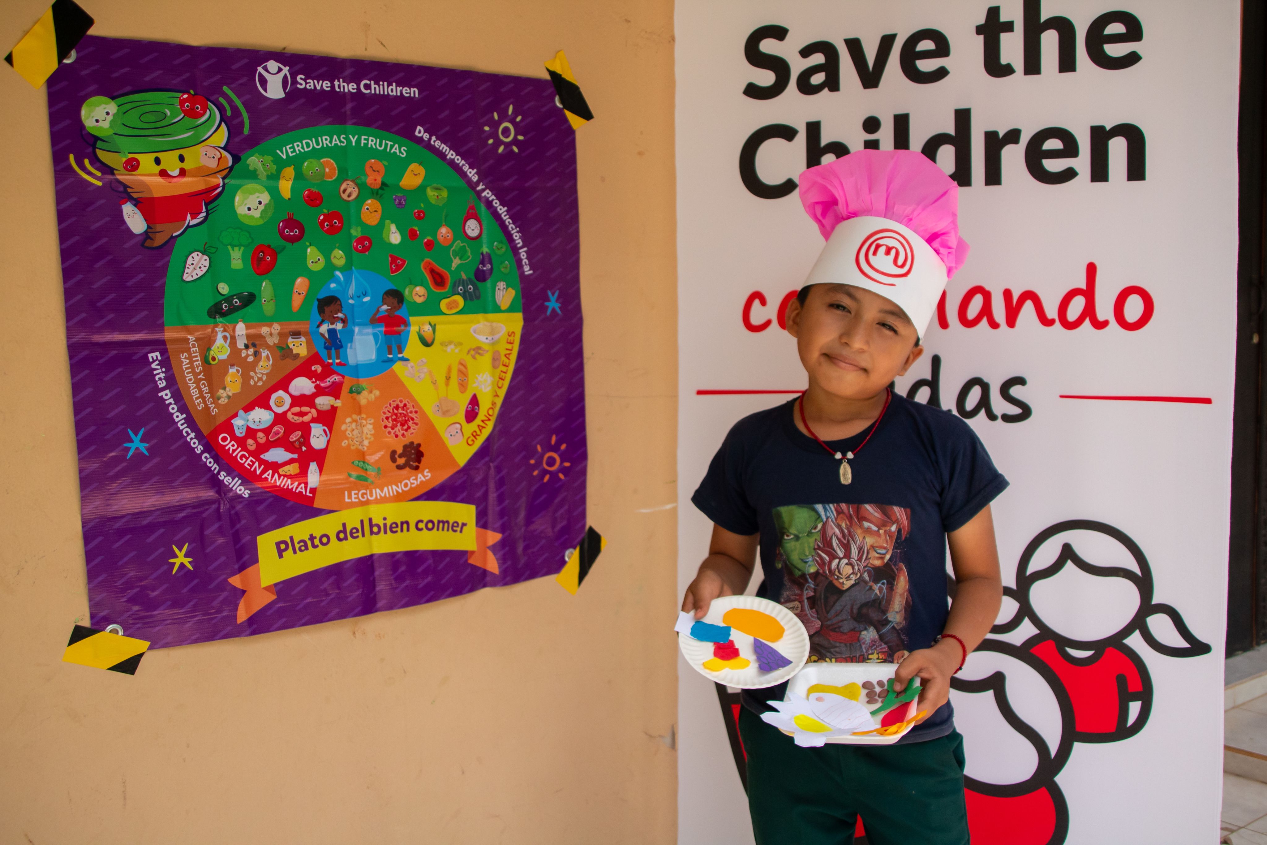 Alex, 10, smiling and showing the final result of his healthy dish