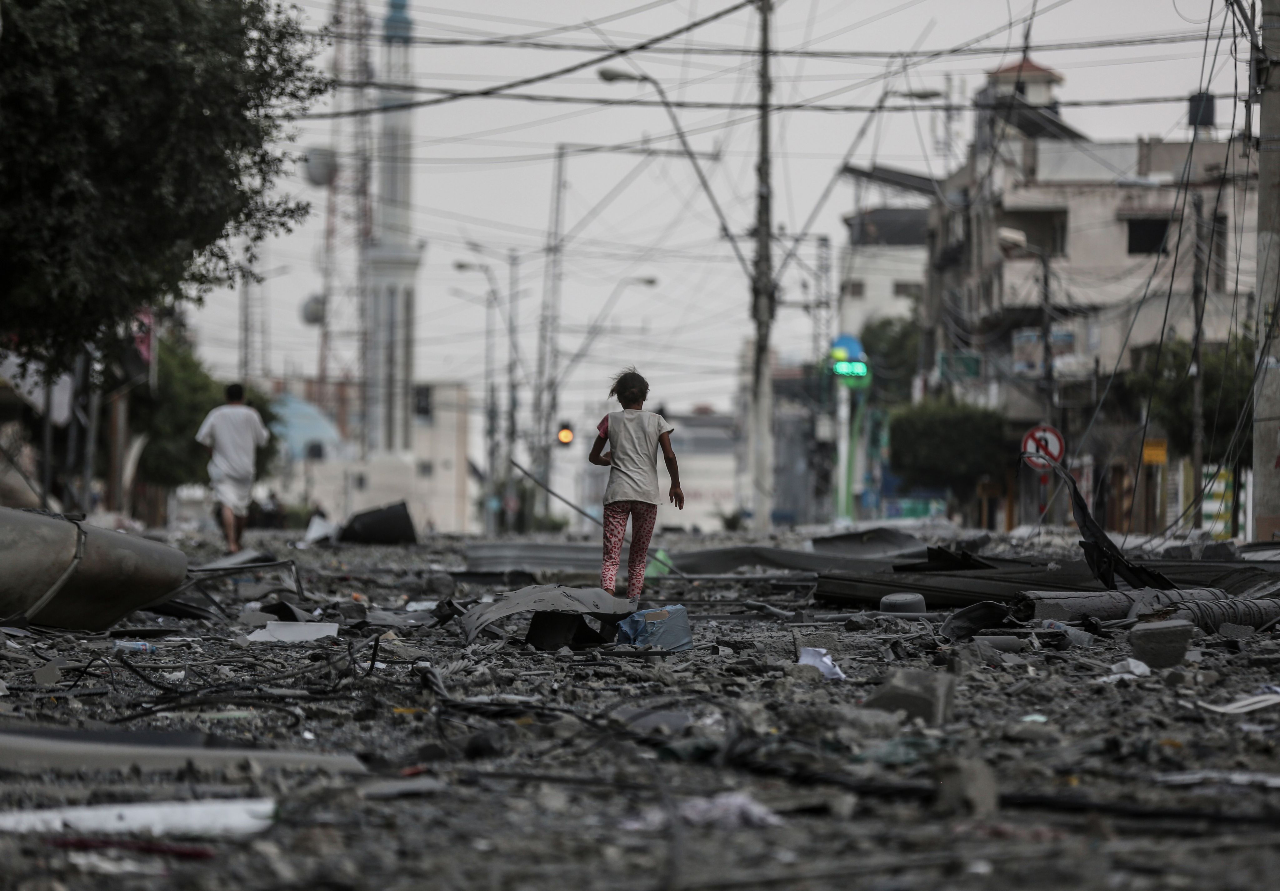 Child runs through rubble after Israel's airstrikes in Gaza. 