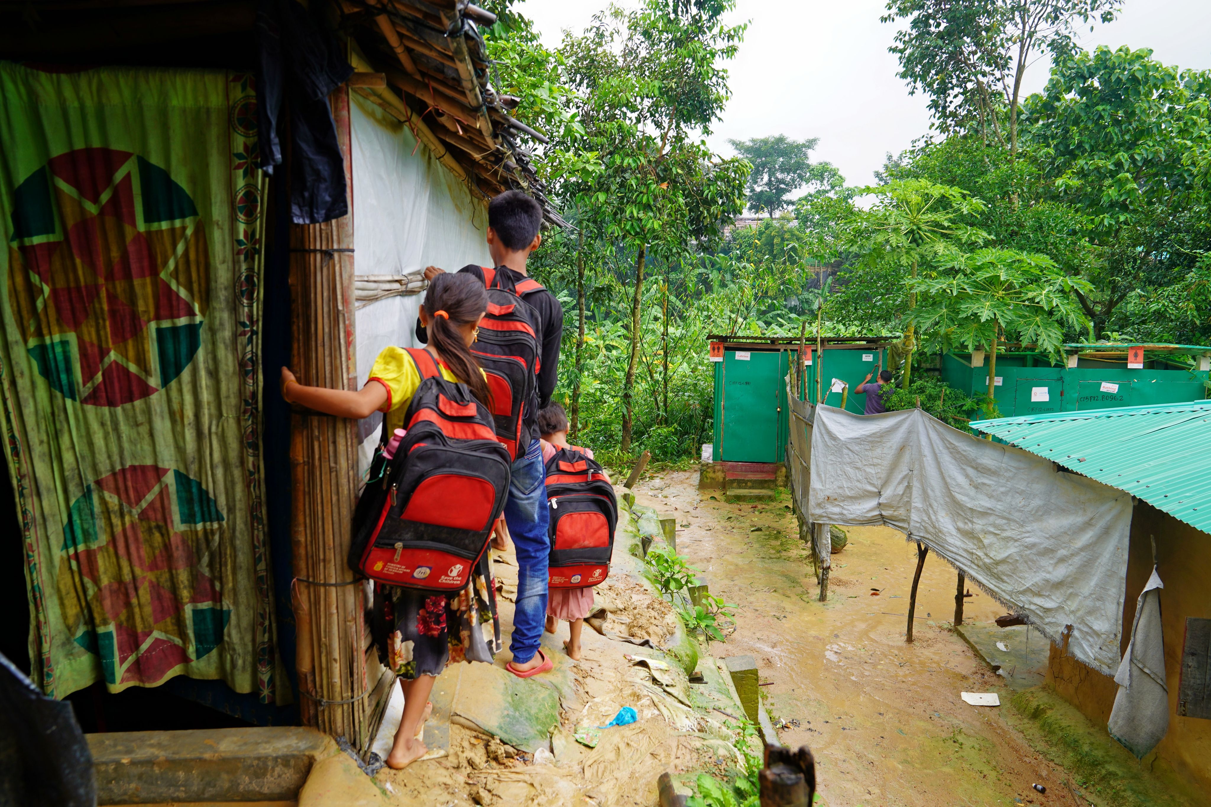 Ayaz*, 15, and his younger siblings en route to a Save the Children supported Learning Centre in Cox's Bazar, Bangladesh. 