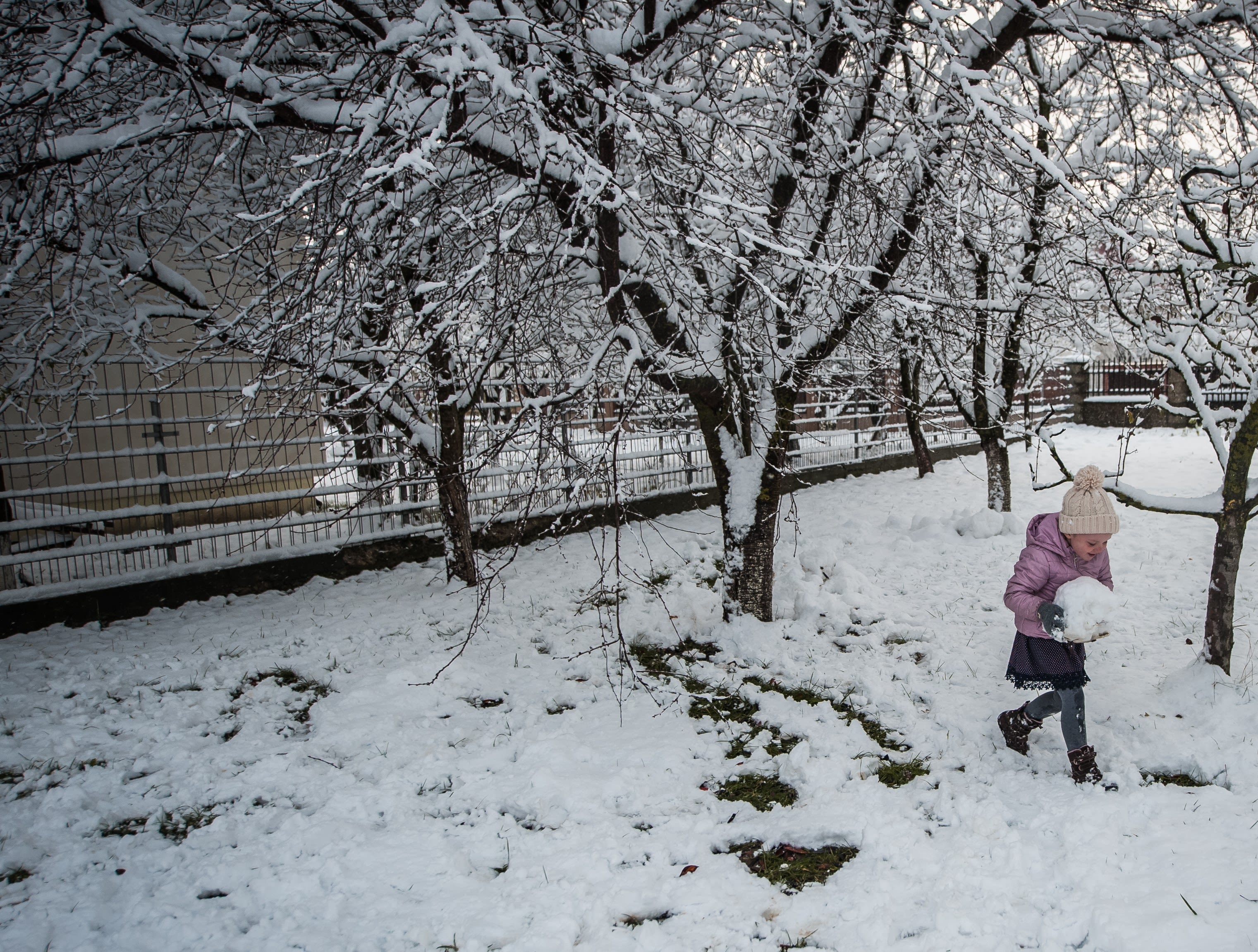 Alyona* 5 plays in the snow at her home in northern Romania.