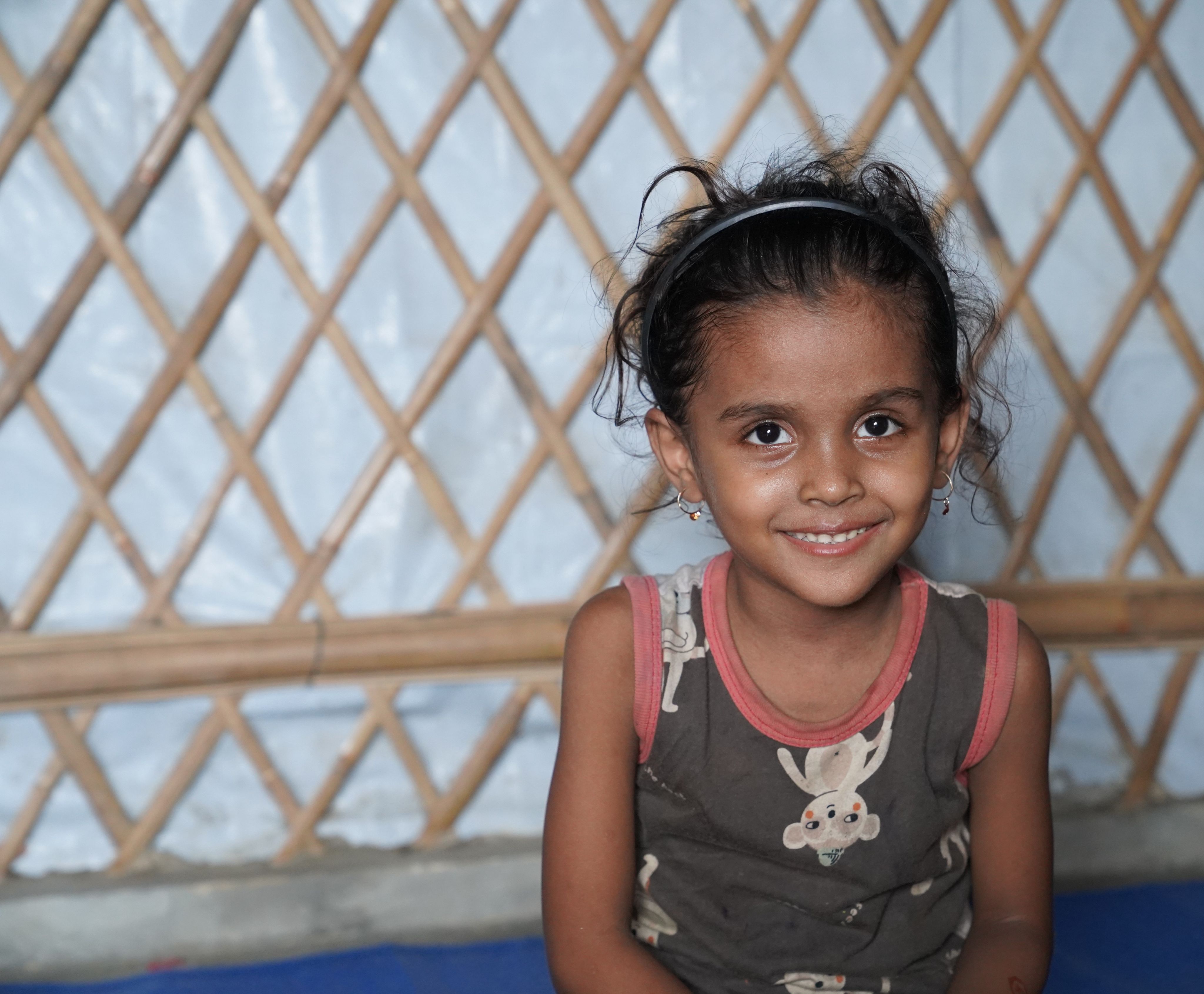 A portrait of Antora*, 5, at her house in Cox's Bazar, Bangladesh.