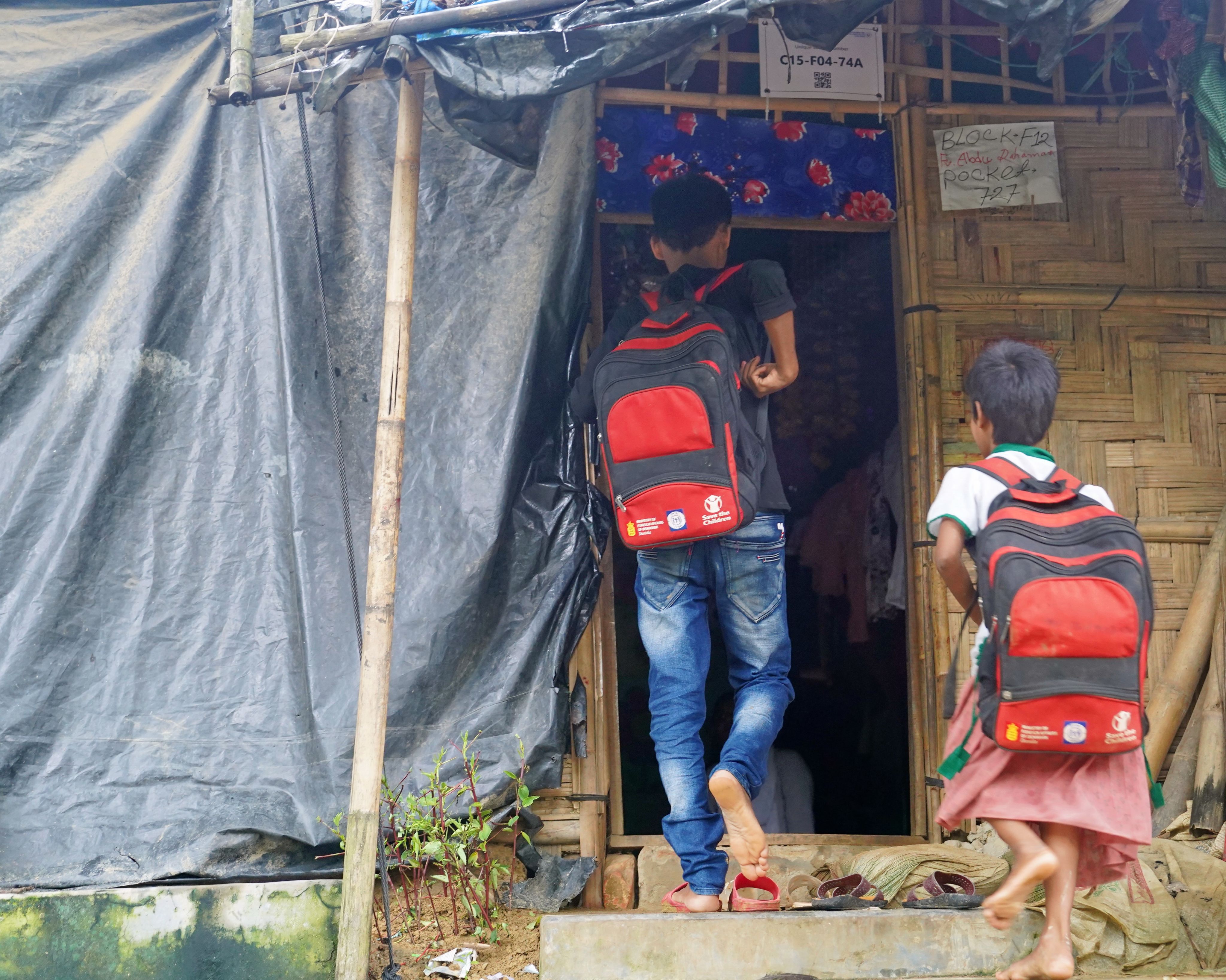 Ayaz*, 15, and his younger sister, 6-year-old Maleka*, walking into a Save the Children supported Learning Centre in Cox's Bazar.