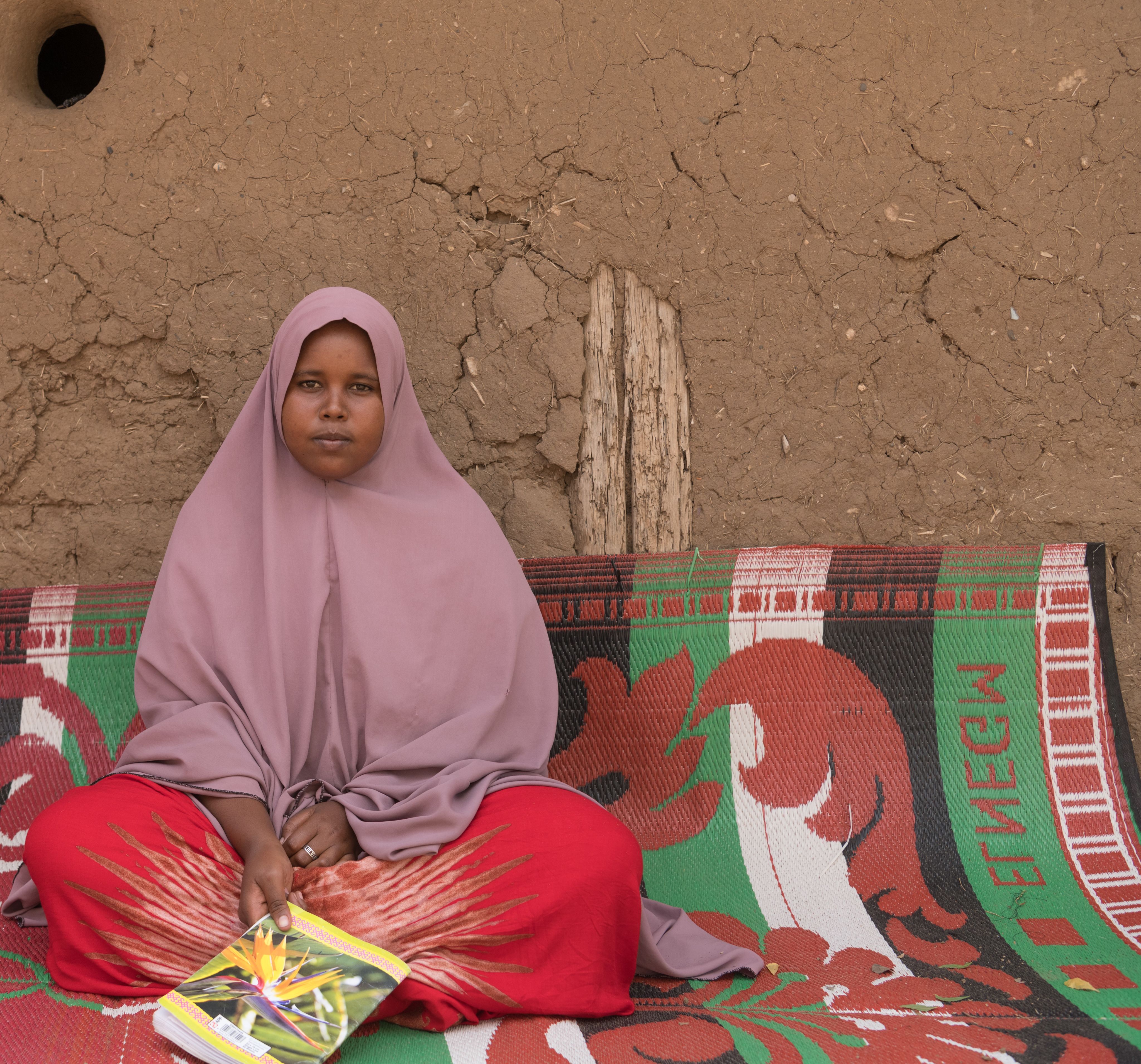 Saeda*, 16, sits in her family home in the Somali region, Ethiopia.