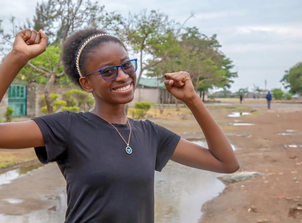 16-year-old Justina, a child climate activist, pictured on a street nearby her house in Zambia. 