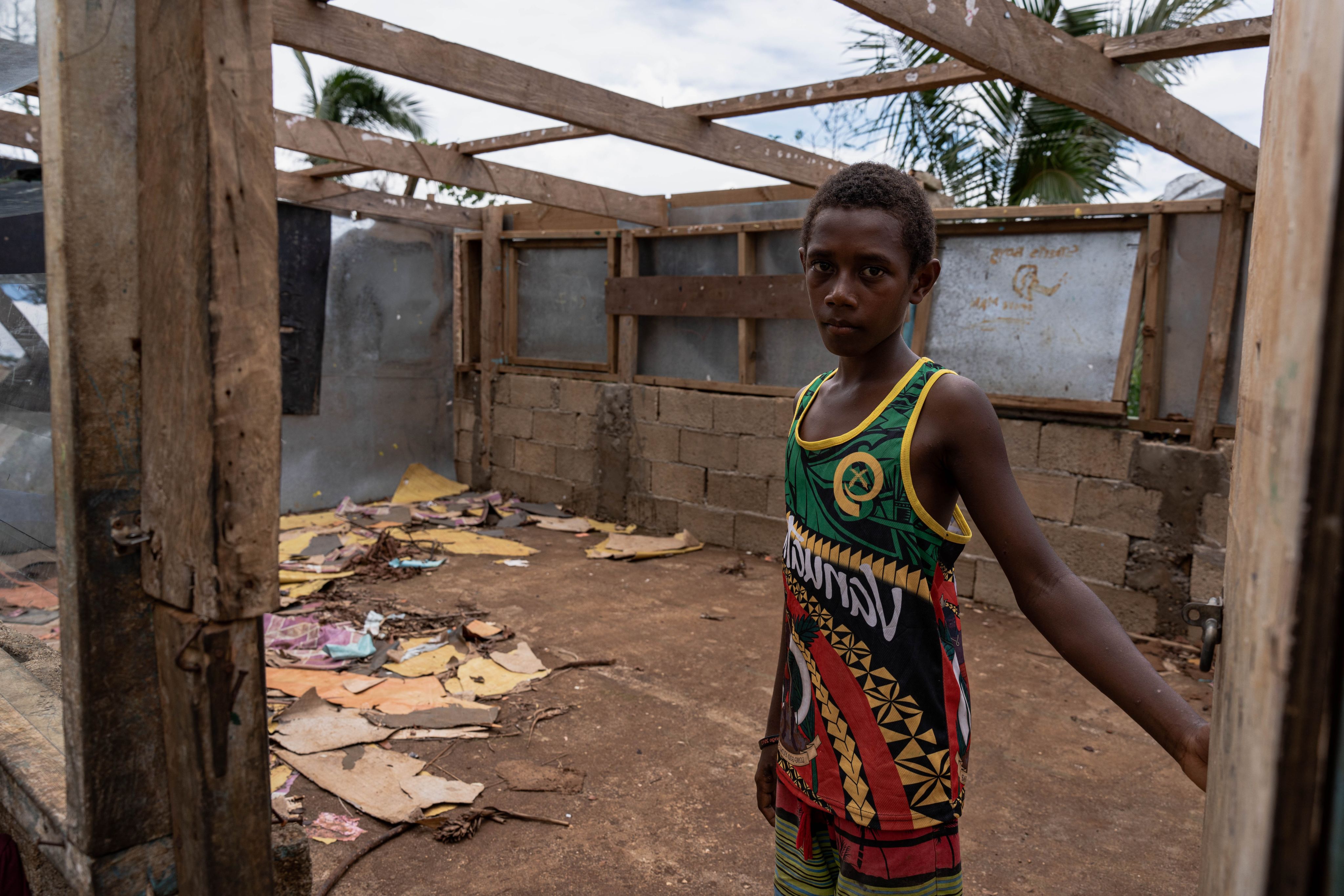 Noa*, 11, pictured inside his damaged school following back-to-back tropical cyclones - Judy and Kevin - that hit his Pacific Island nation of Vanuatu.