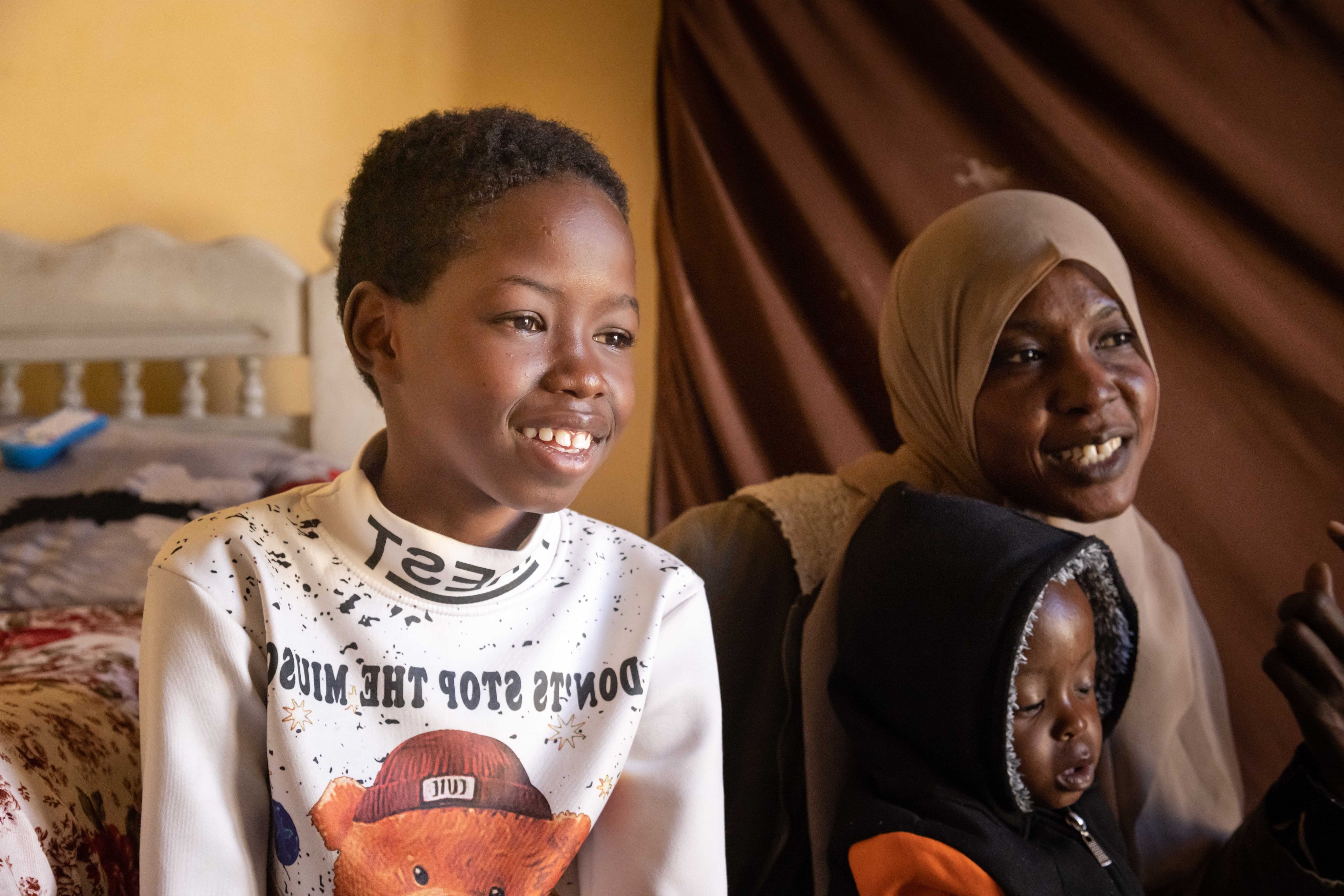 Asaad, 13, and his mother and brother in their home in Cairo, Egypt.