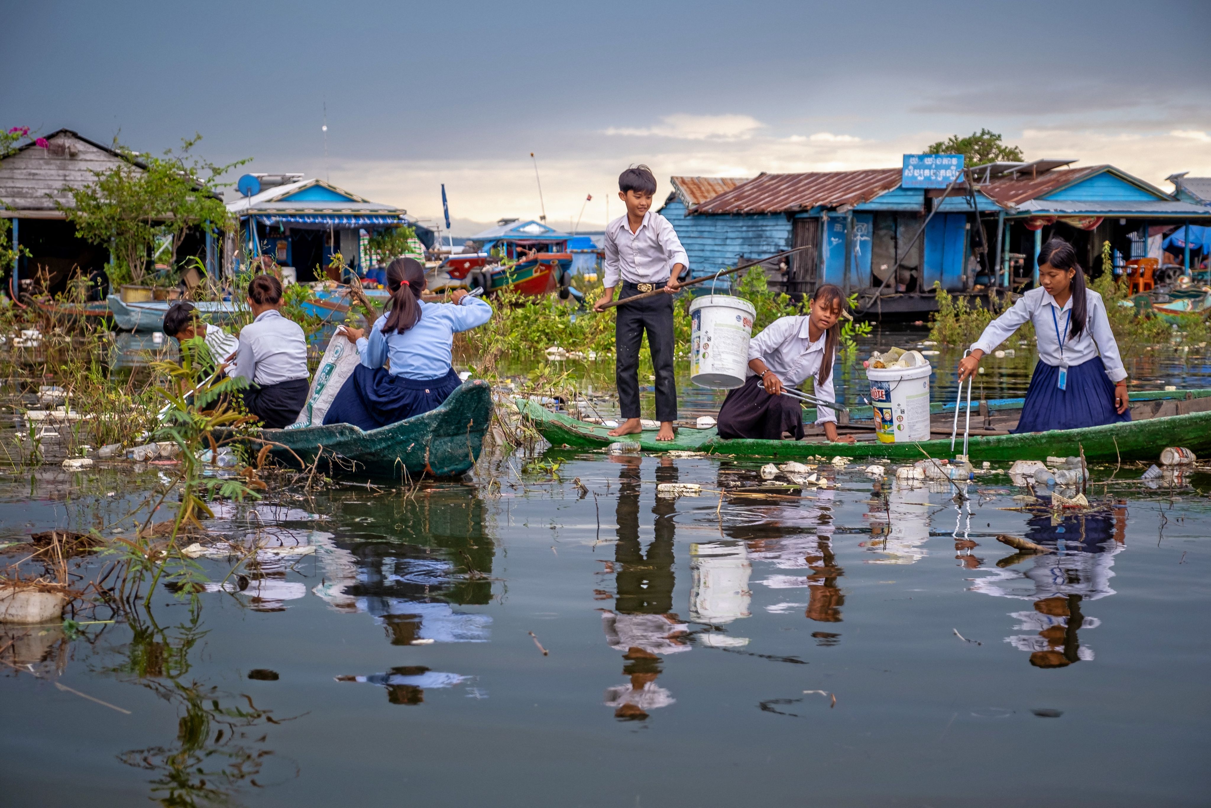 Ratana, 12, and her classmates collect rubbish from Tonle Sap Lake, Cambodia.