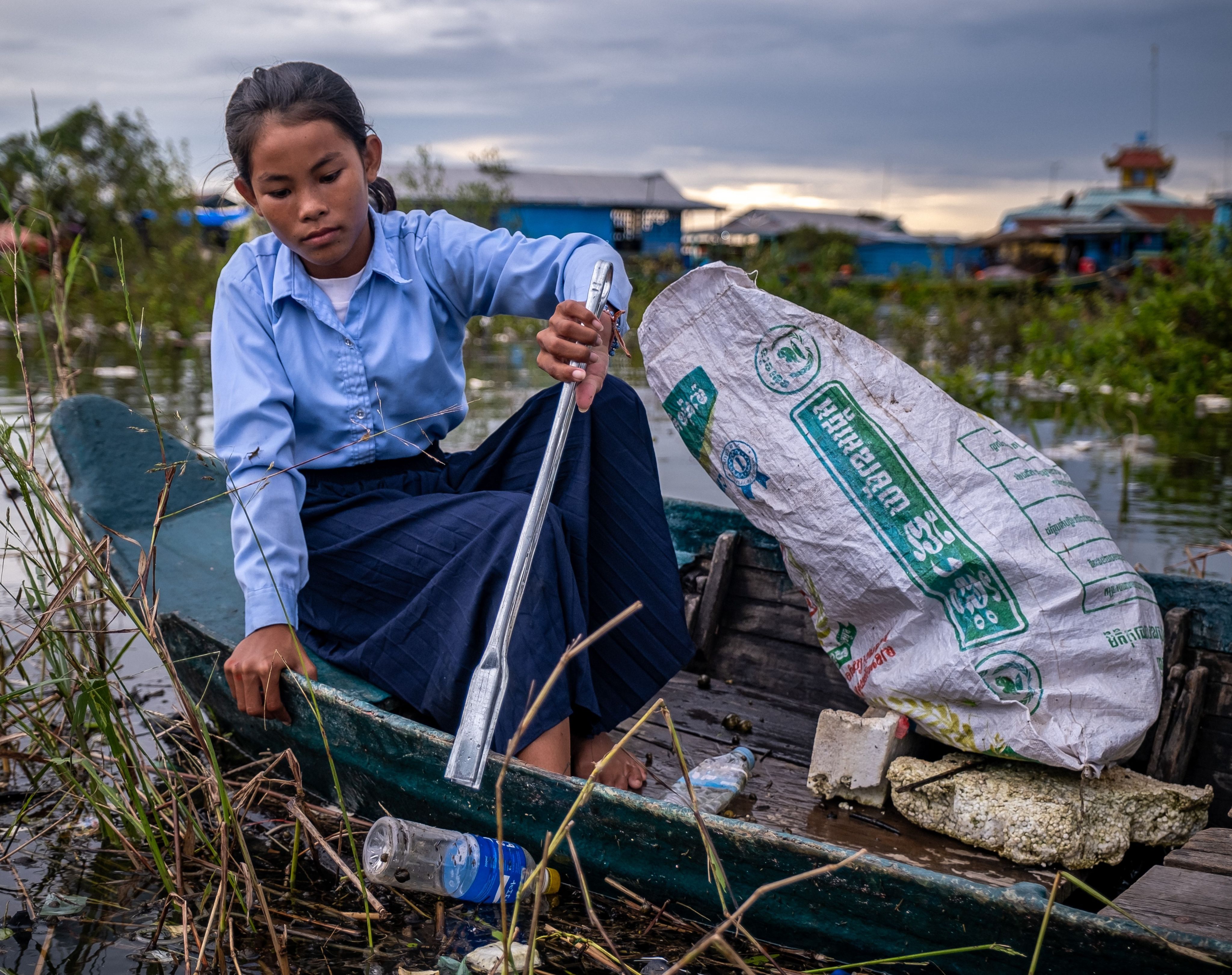 Ratana, 12, collects rubbish from Tonle Sap Lake, Cambodia.