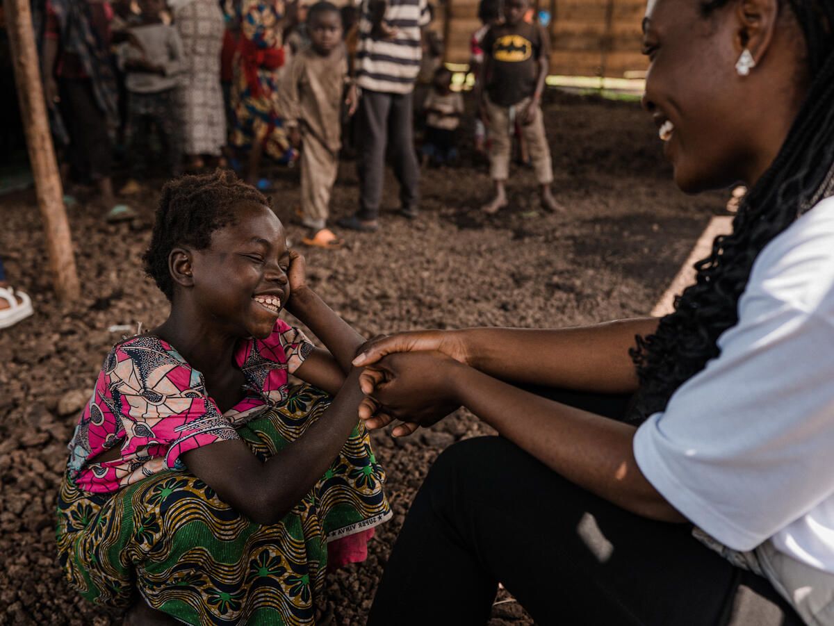 Liliane*, 13, lives in a camp for displaced people in Democratic Republic of Congo. Here, she speaks to Furaha, a staff member at Save the Children’s Child Friendly Space where Liliane can take a break from her daily chores and focus on being a kid again. Photo: Hugh Kinsella Cunningham /Save the Children 
